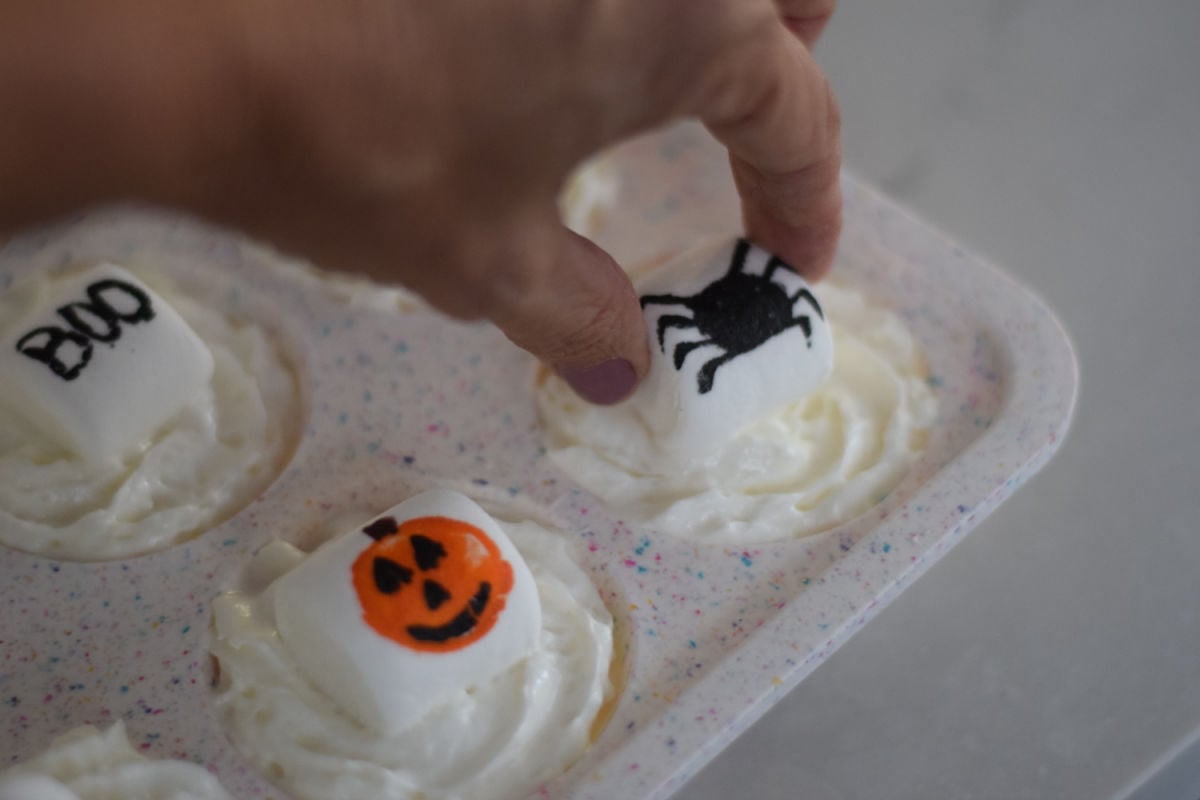 making Halloween frozen whipped cream toppers