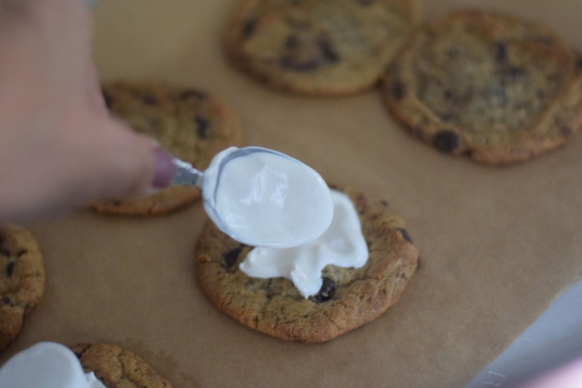 spreading chocolate onto cookie