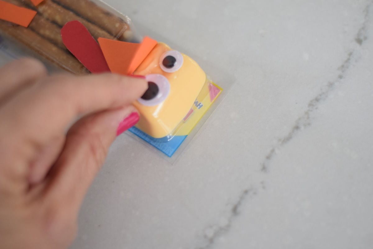 gluing eyes to turkey snack