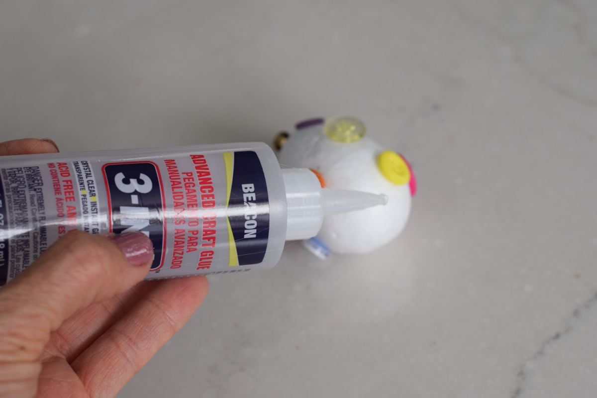 gluing buttons on foam egg