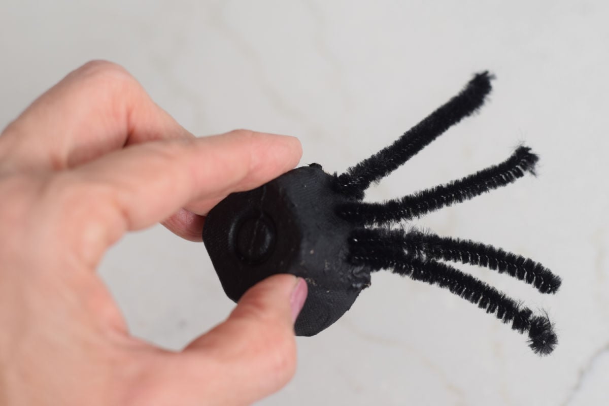 adding pipe cleaner legs to spider craft