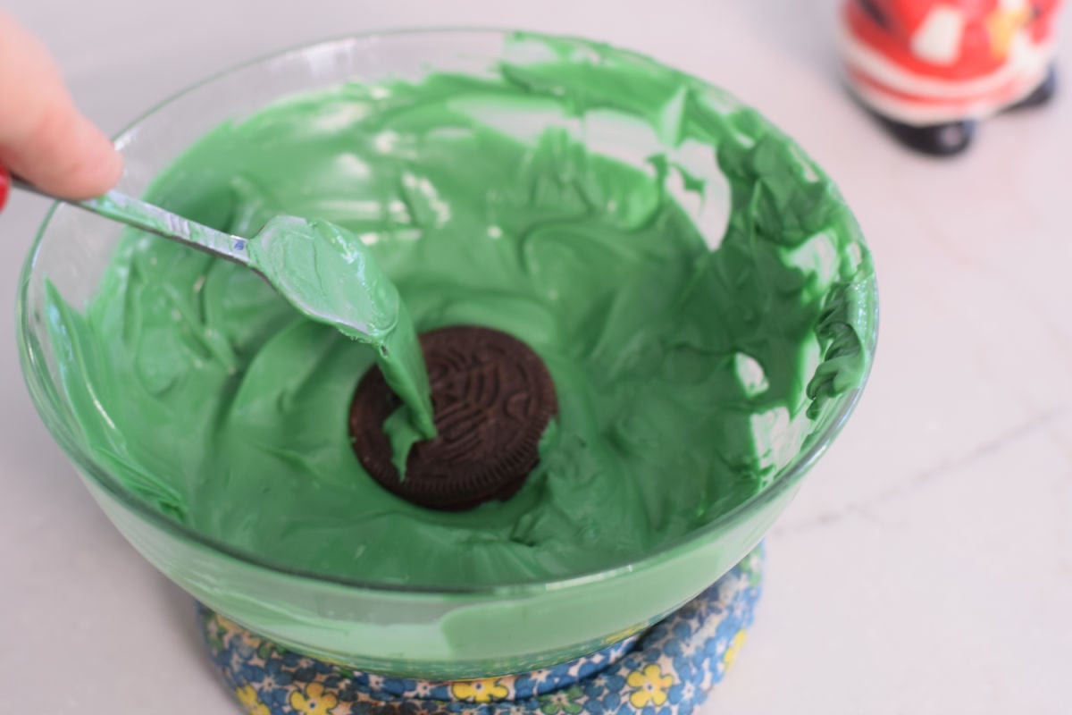 dipping cookie into chocolate 