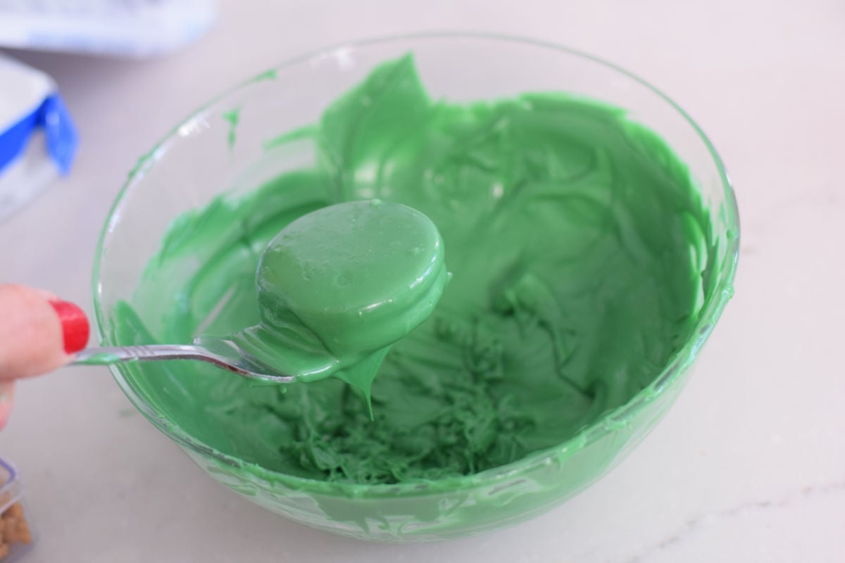 dipping cookie into chocolate 