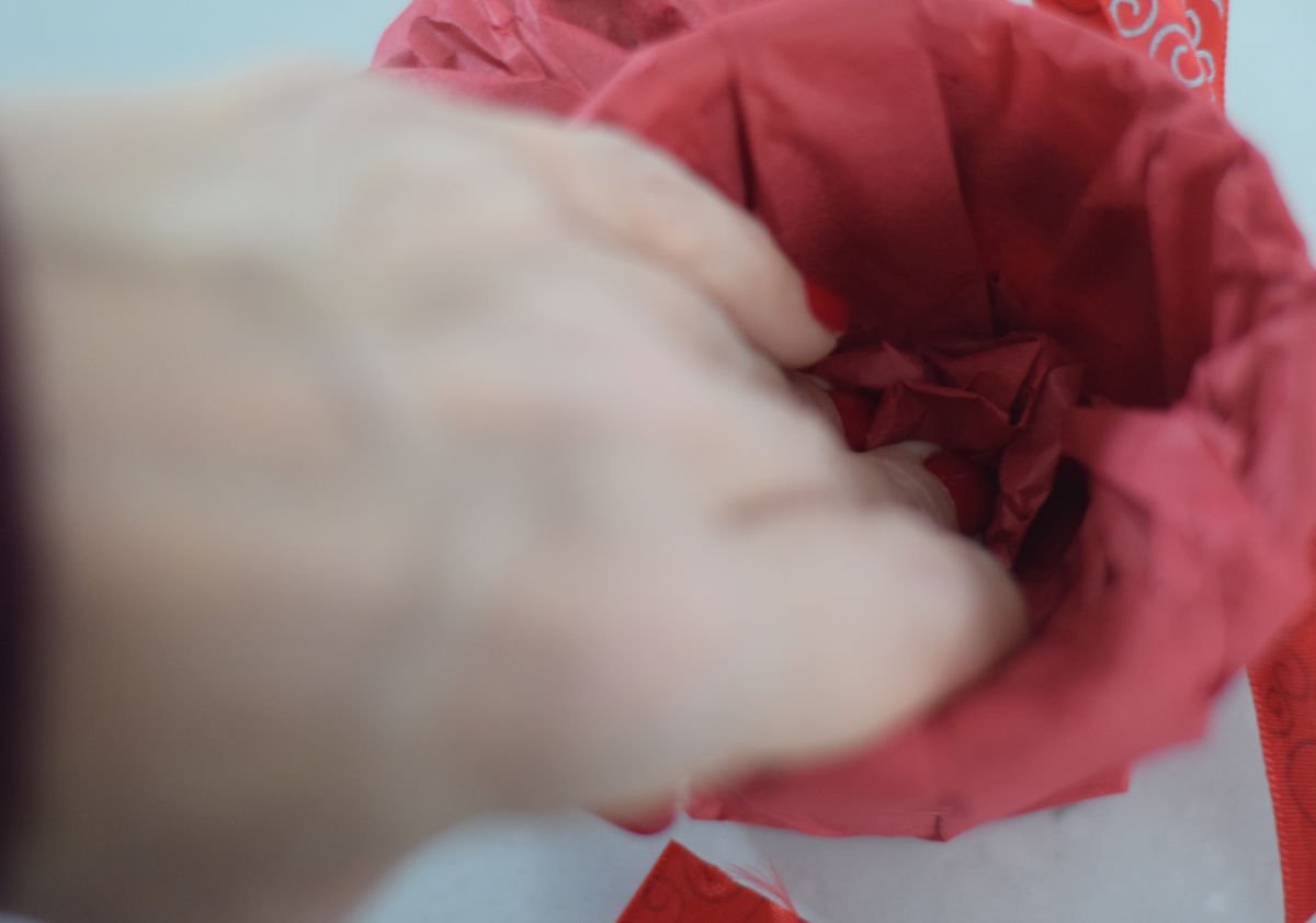 tucking tissue paper into cup