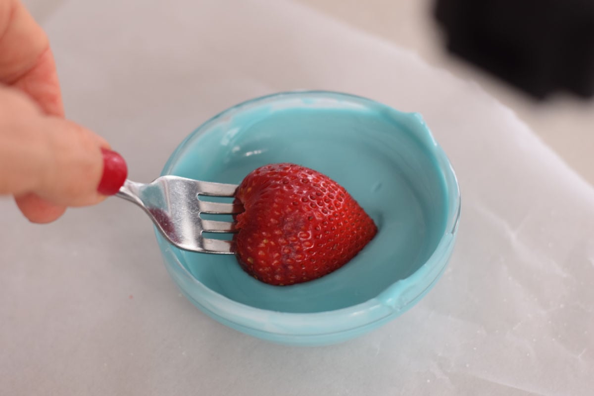 dipping strawberry into chocolate