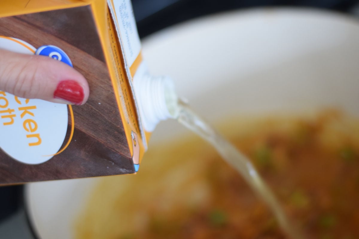 pouring broth into soup