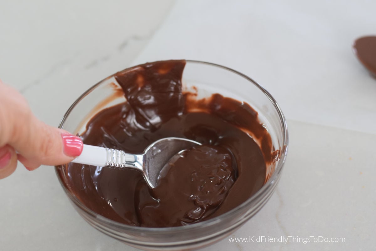 dipping spoon into chocolate
