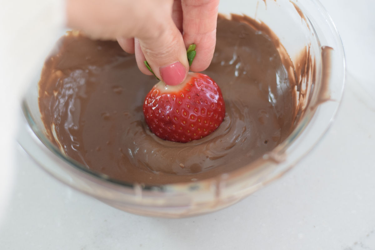 dipping strawberries into chocolate 