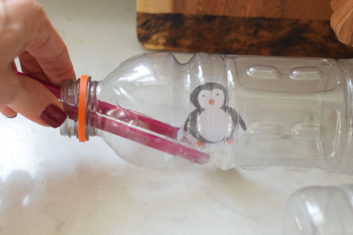attaching penguin to sensory bottle