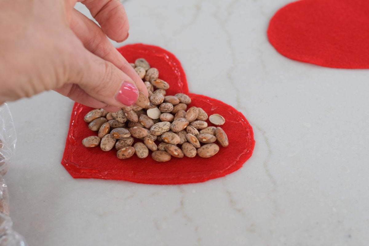 adding beans to felt heart 