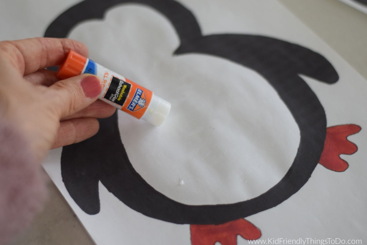 applying glue to penguin craft