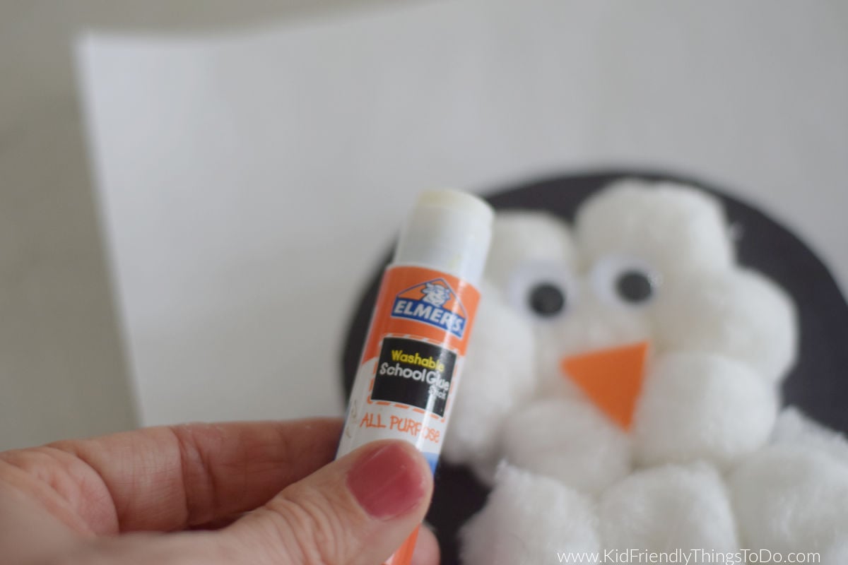 adding eyes and beak to penguin craft