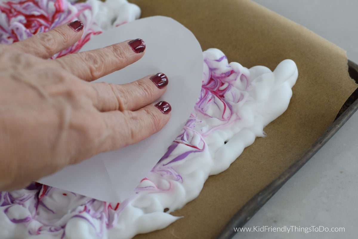 pushing paper onto shaving cream and paint