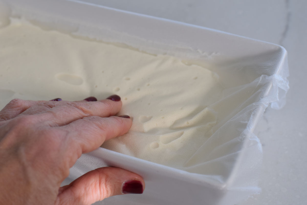 pressing bubbles out of ice cream
