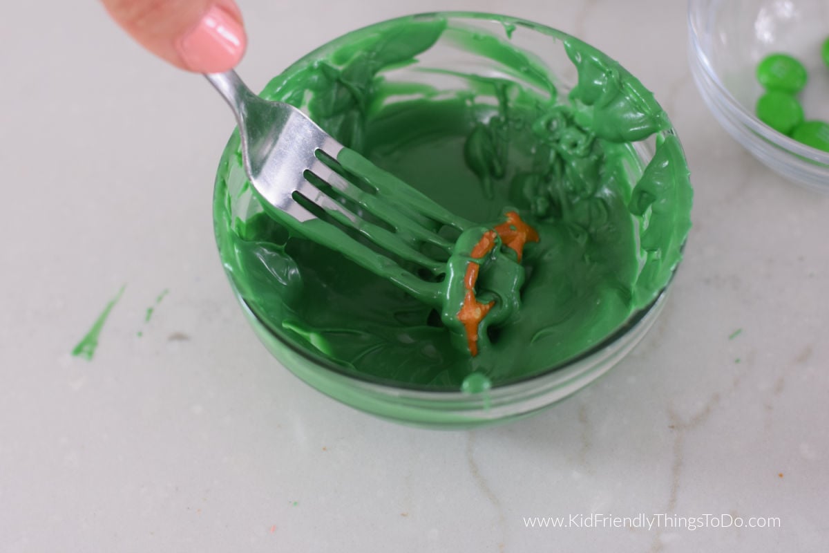 dipping pretzels into chocolate