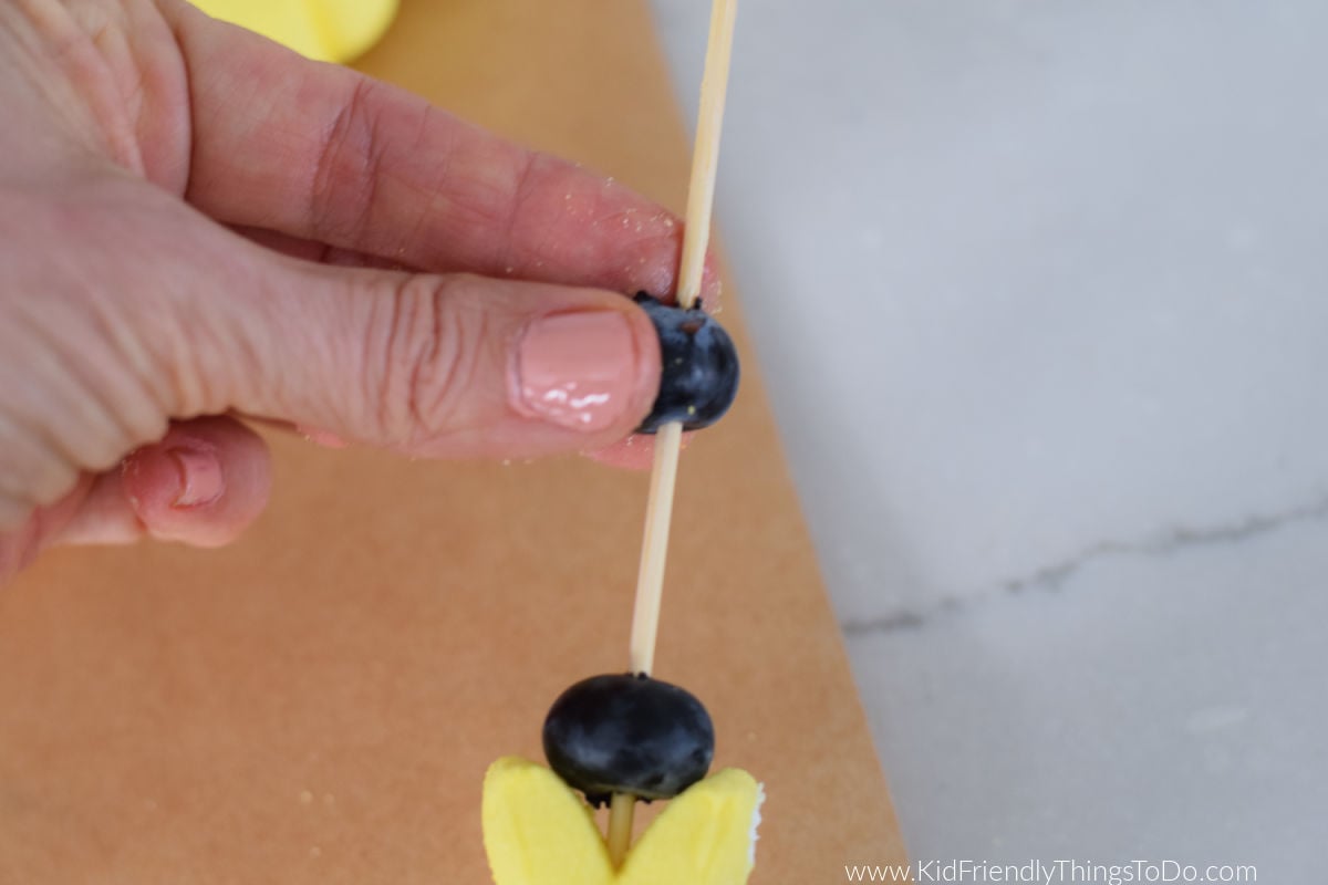 adding fruit to a peep skewer 
