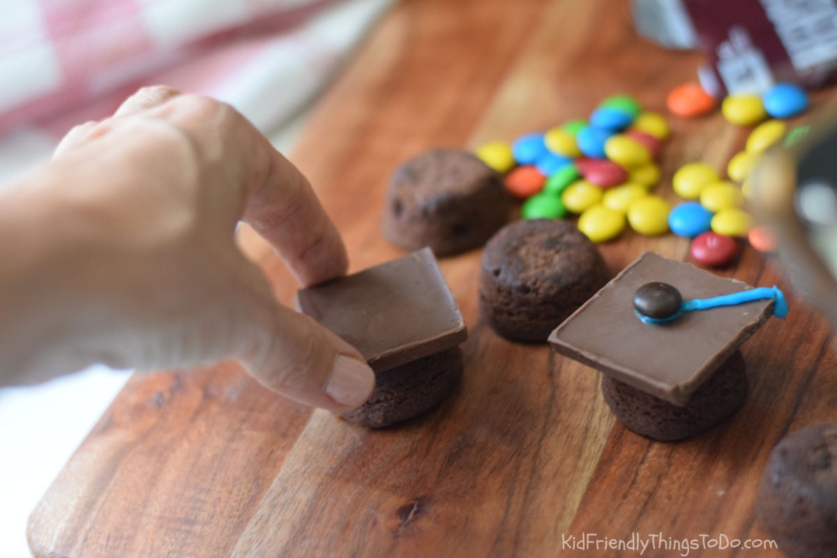 adding chocolate square to brownie grad caps 