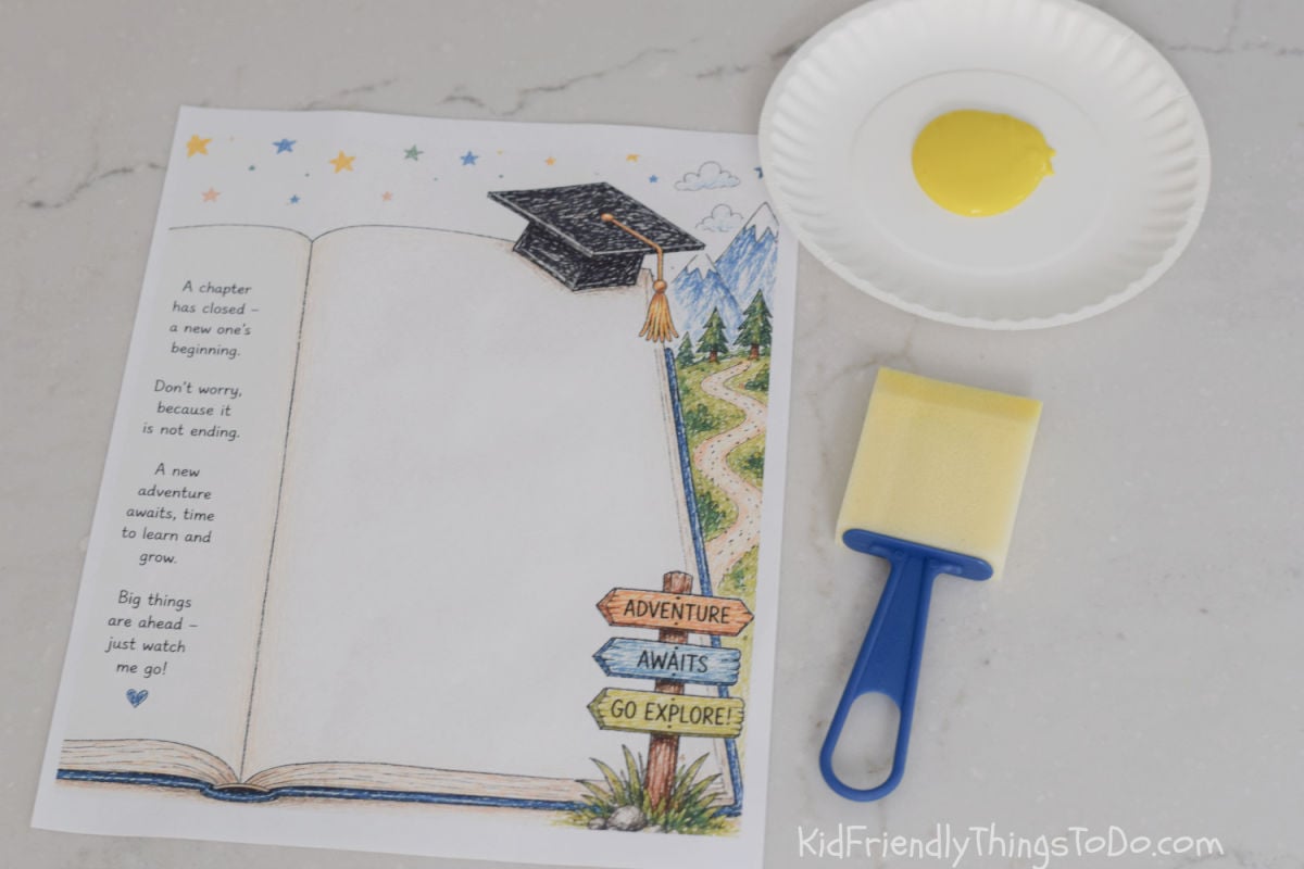 supplies for Graduation handprint keepsake printable with blue paint handprint under a graduation cap on an open book design