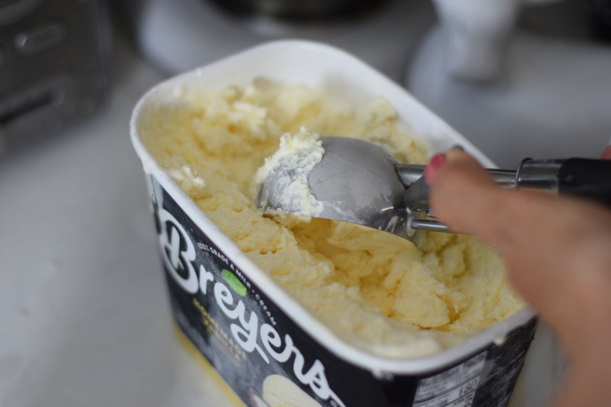 scooping vanilla ice cream for milkshake recipe 