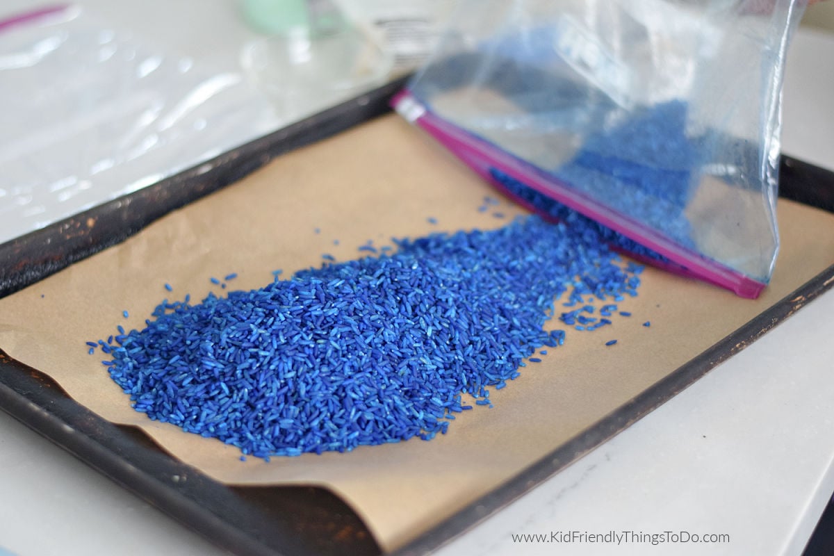 pouring out colored rice for minion jar craft 