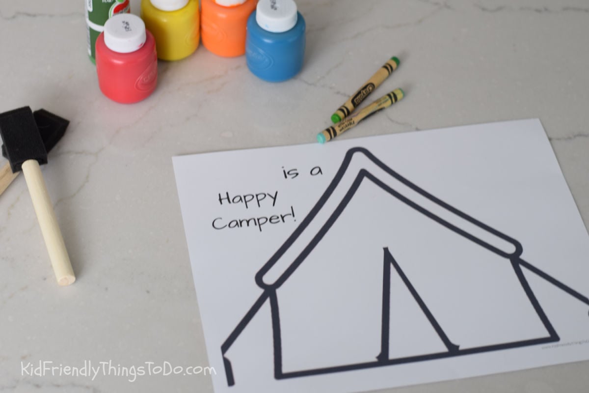 happy camper camping craft printable and supplies like paint and crayons 