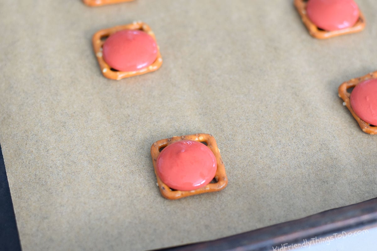 melted chocolate melts on pretzel crisp squares 