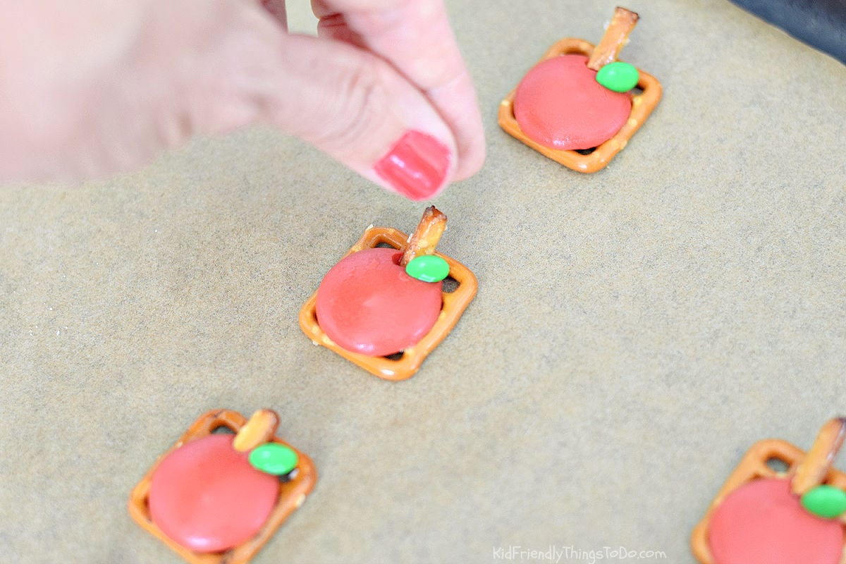 adding pretzel stem and mini M&M to apple pretzel bites 