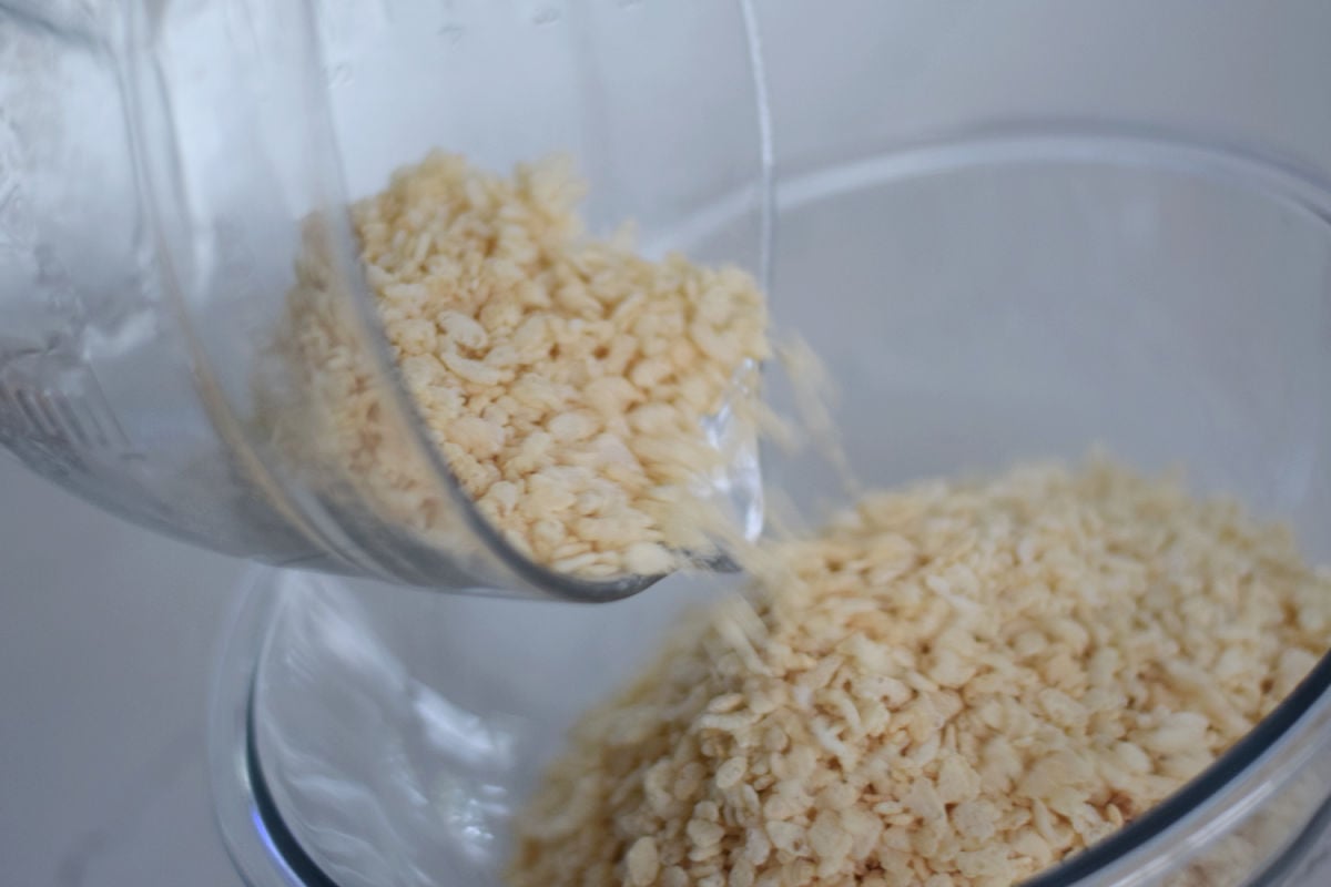 Rice Krispies cereal being poured into a large mixing bowl