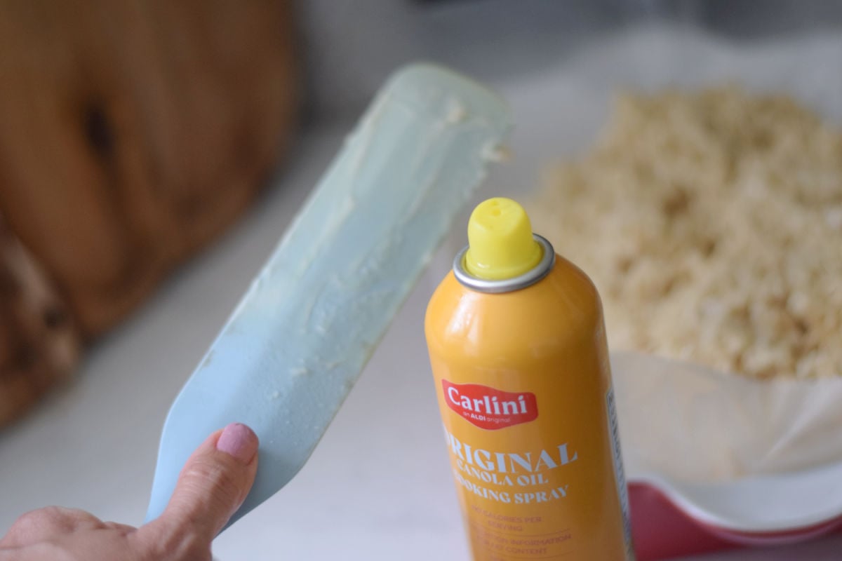 Silicone spatula sprayed with cooking spray for spreading Rice Krispie Treats