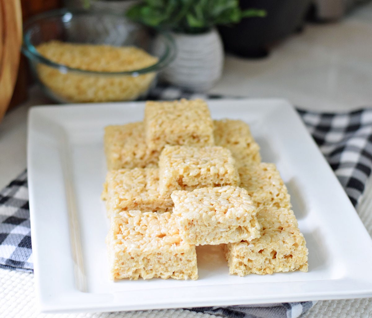 Homemade Rice Krispie Treats stacked on a white serving plate