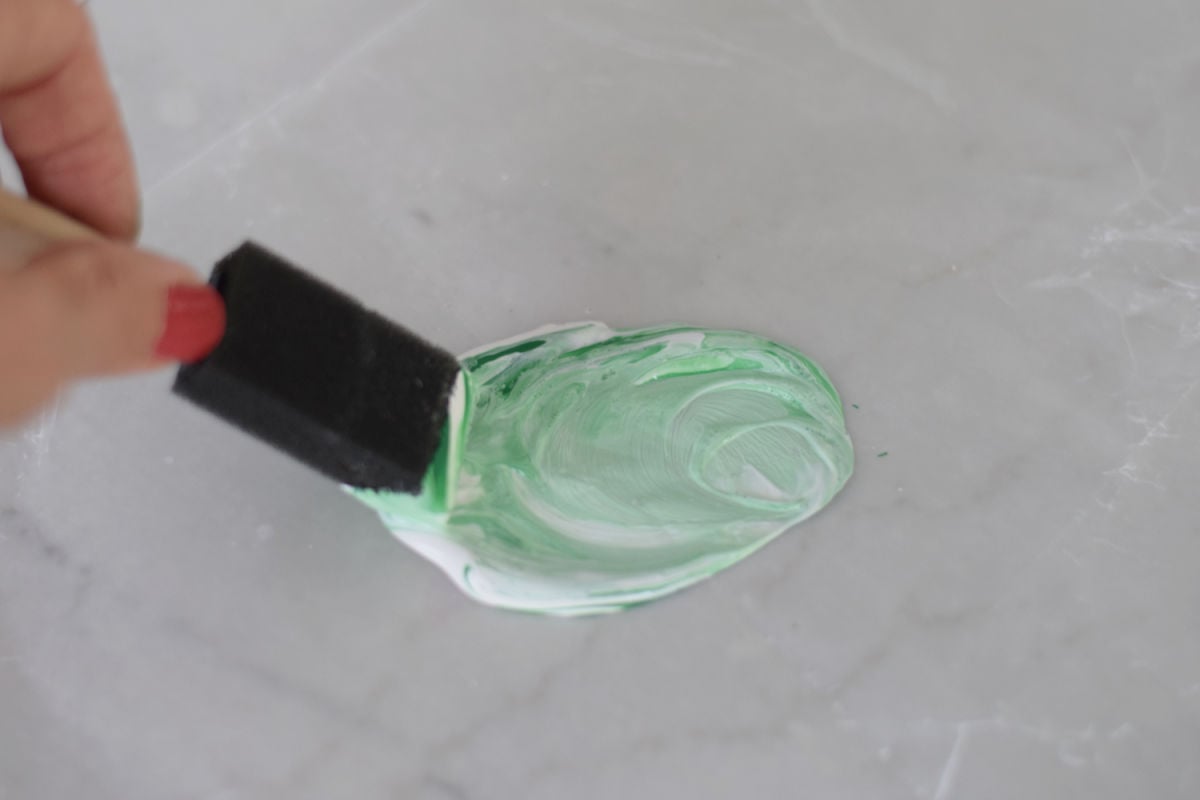 mixing green and white paint for cauldron craft