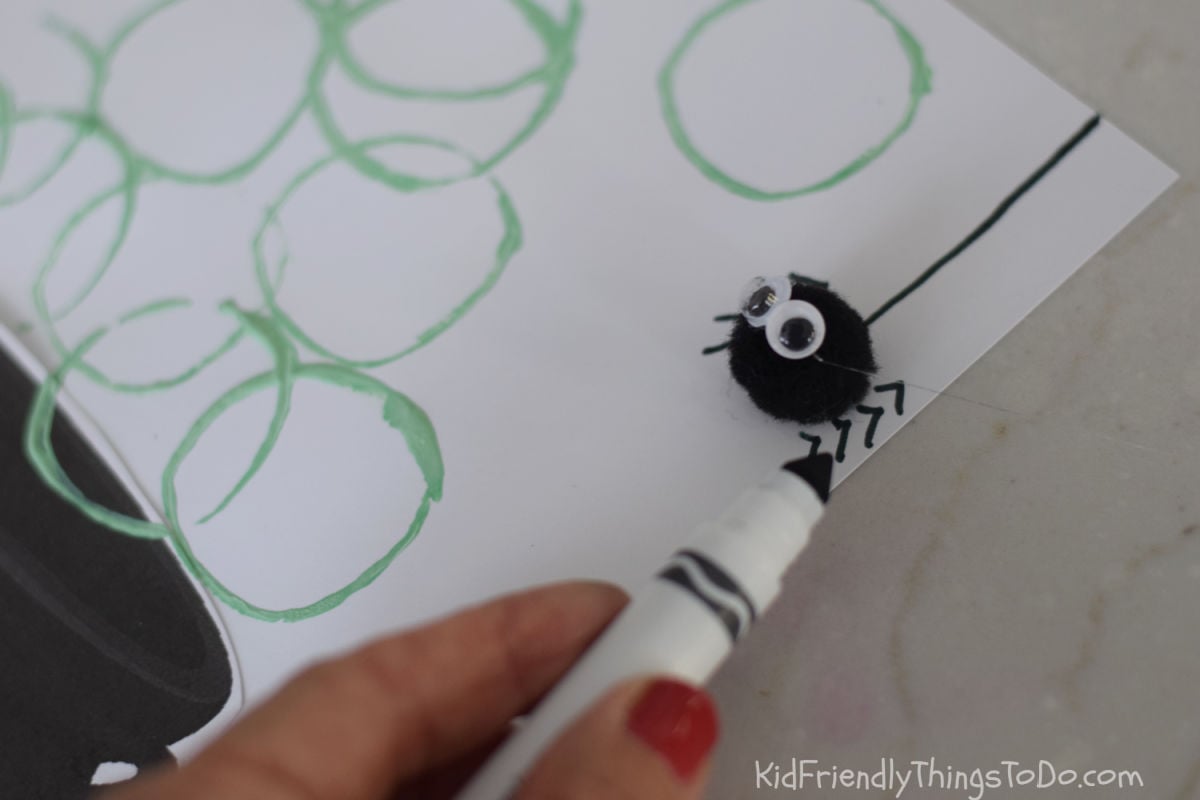 drawing spider legs on witch cauldron printable craft