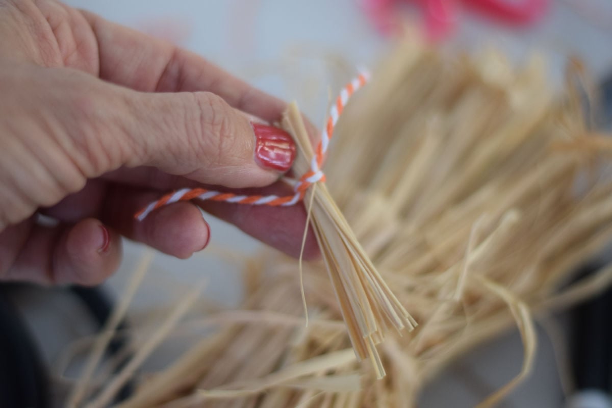 bundling raffia for witch broom on halloween witch cauldron craft