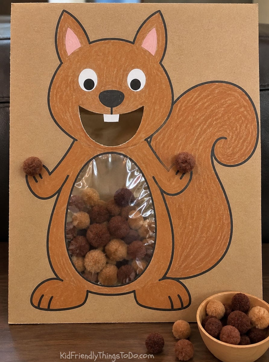 Feed the Squirrel printable activity with brown and tan pom-poms collecting inside a clear belly pocket