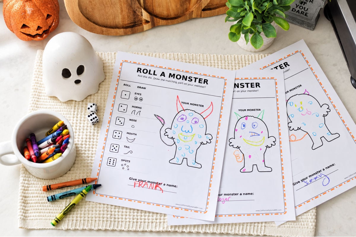 Three completed Roll a Monster printables with colorful drawings made by kids, shown with dice and crayons.