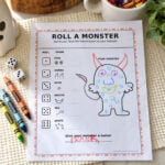 Completed Roll a Monster printable with a colorful monster named Franka, dice, and crayons.