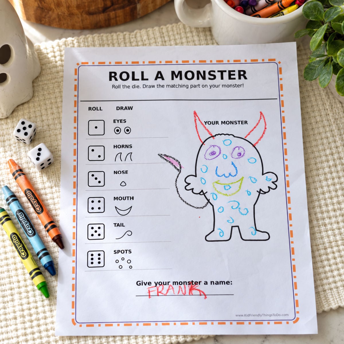 Completed Roll a Monster printable with a colorful monster named Franka, dice, and crayons.
