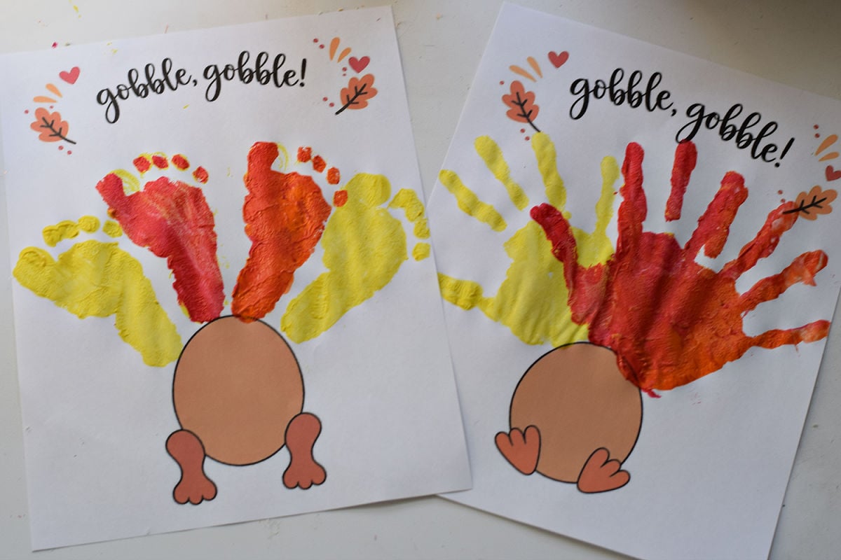 Colorful red orange and yellow handprints arranged as feathers for a Thanksgiving turkey craft