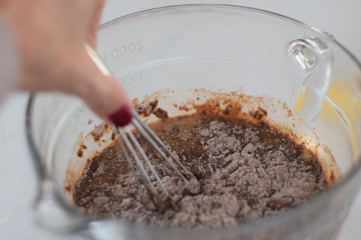  Whisking chocolate instant pudding mix into milk in a glass mixing bowl