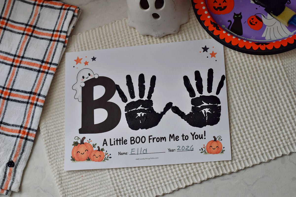 BOO handprint keepsake with black handprints beside a printed B and the message A Little BOO From Me to You.