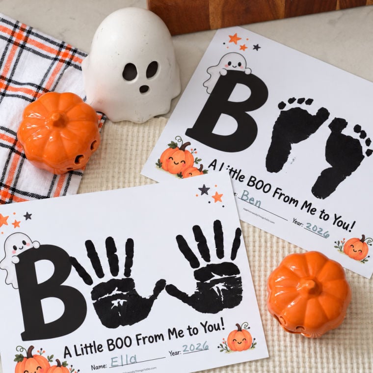 Halloween handprint and footprint keepsakes spelling BOO on “A Little BOO From Me to You” printables, displayed with pumpkin and ghost decorations.