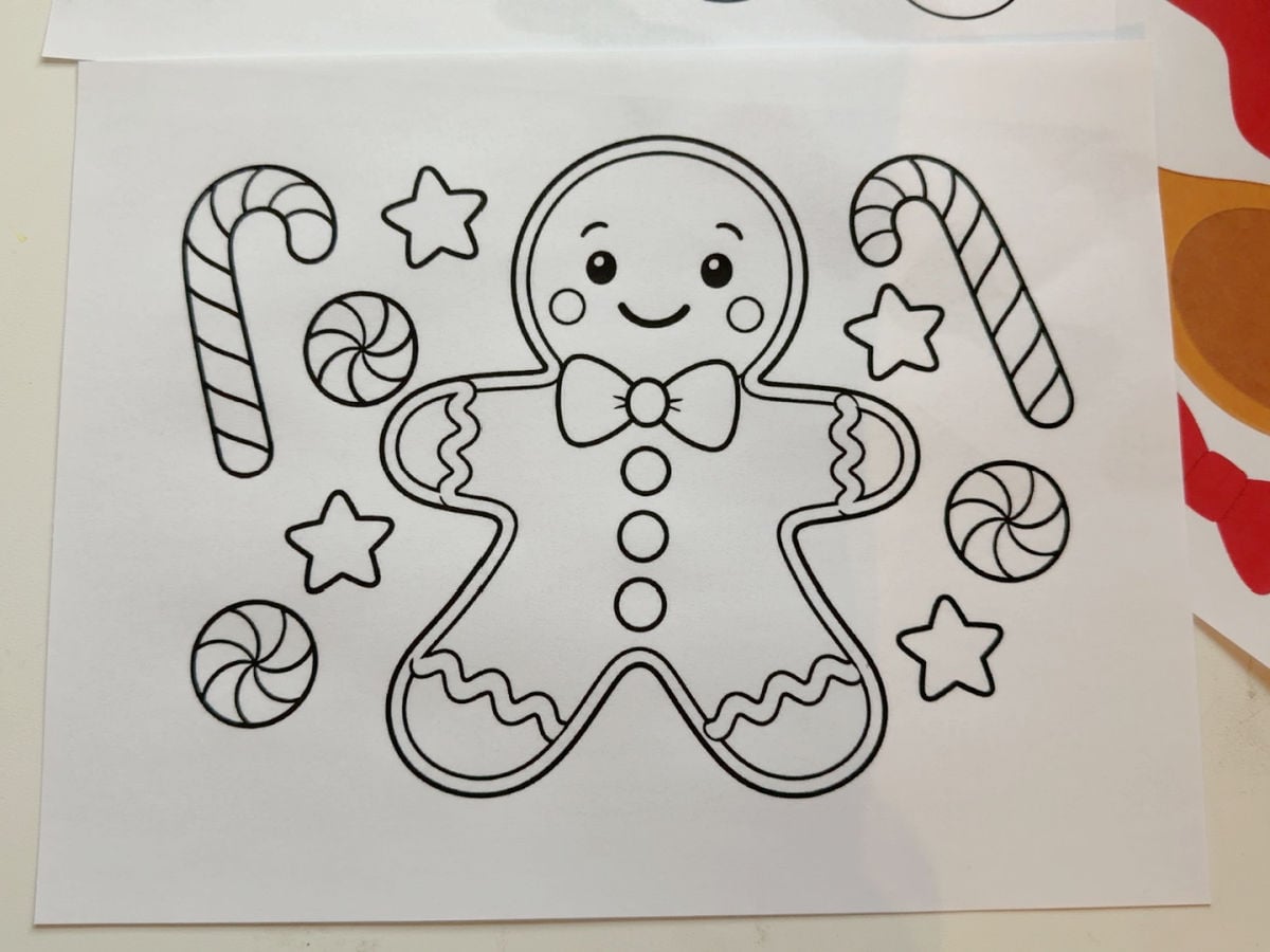 Printable gingerbread man coloring page with candy canes, peppermint candies, and stars.